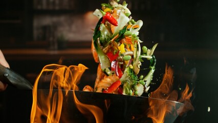 Freeze Motion of Flying Asian Wok Ingredients with Fire Flames