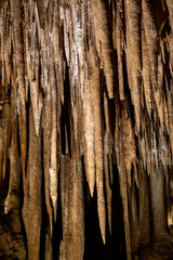 Stalactites in cavern: natural rock formations and textures from ceiling perspective