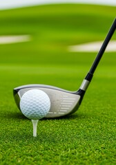 Golf ball teed up with golf club on green course