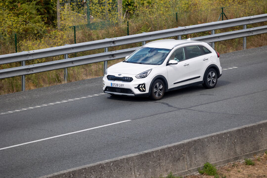 White kia niro driving on the highway