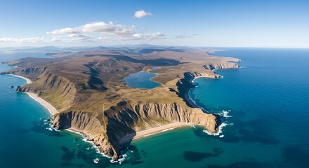 Aerial view of a rugged coastline with cliffs beaches and turquoise water under a clear blue sky landscape