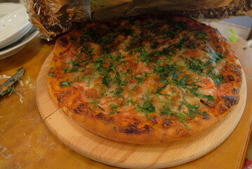 Beautiful pizza after cooking in the oven on the protvne visible product close-up healthy food