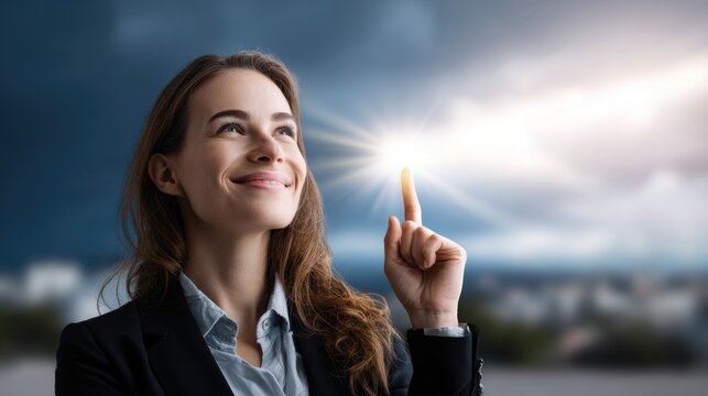 A radiant young woman in business attire smiles, looking up and pointing toward a glowing light, representing breakthrough ideas, hopeful vision, and future growth in the sky.