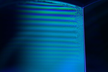 Blue ink macro abstraction, movement of paint spots in circles on the surface of a water film