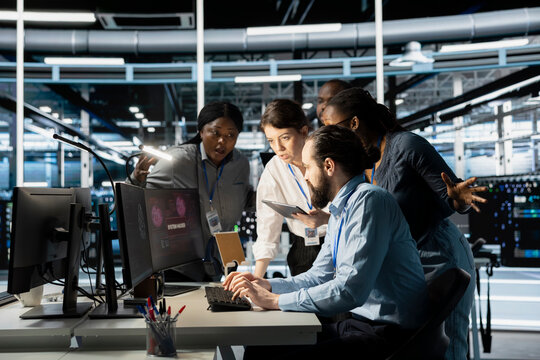 Engineers reviewing AI systems alerts after detecting irregular network activity patterns. IT team evaluating flagged events using artificial intelligence threat detection tools