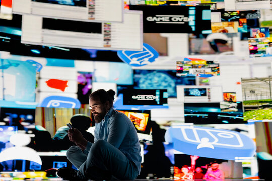 Young guy in misery is affected by anxiety and social depression, highlights suffering due to dangerous social media overuse. Expressive information from constant interaction causes distress.