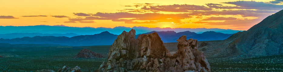 Aerial Rocky Outcrops and Mountains at Sunset in Nevada Desert