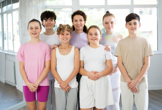 Group portrait of cheerful teenage dancers in row in a choreographic studio - Powered by Adobe