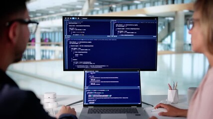 Developer Typing Code On Laptop In Office
