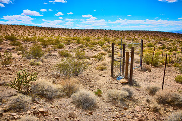 Desert Fence and Scrub Vegetation under Blue Sky in Nevada