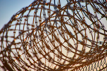 Barbed wire fence with desert landscape in Las Vegas Nevada under clear blue sky