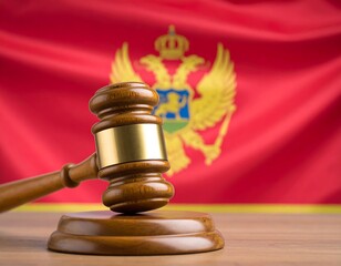 Wooden gavel on a table in front of a flag
