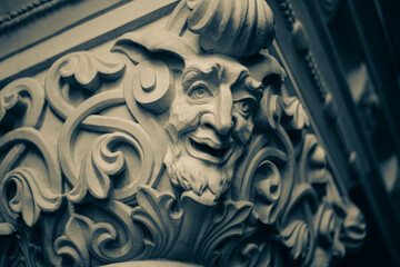 The capital of the antique column is completely covered with floral ornaments. Among the curls and...