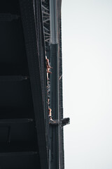 Maria Pia Bridge Porto Portugal, feet and legs hanging over the edge