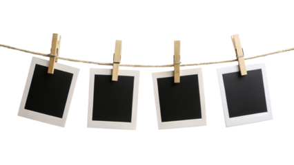 Four blank instant photo frames hanging on a rope