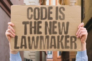 “Code is the new lawmaker” appears as a protest slogan about algorithm governance and AI...