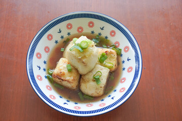 Agedashi Tofu is a spicy fried tofu dish from Japan. Silken tofu or silken bean curd, kinugoshi, is diced and then sprinkled with potato starch or cornstarch.