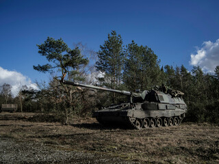 Fototapeta premium PzH 2000NL howitzer positioned in forest environment during tactical exercise