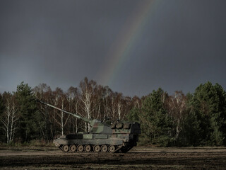 PzH 2000NL howitzer positioned under dramatic dark sky during training exercise