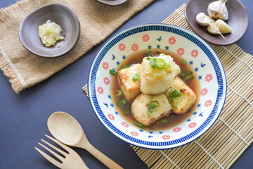 Agedashi Tofu is a spicy fried tofu dish from Japan. Silken tofu or silken bean curd, kinugoshi, is diced and then sprinkled with potato starch or cornstarch.