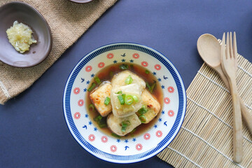 Agedashi Tofu is a spicy fried tofu dish from Japan. Silken tofu or silken bean curd, kinugoshi, is diced and then sprinkled with potato starch or cornstarch.