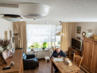 Modern living room with visible ceiling-mounted surveillance camera and comfortable home environment