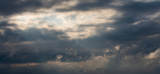 Evening sunset sky background with bright dramatic clouds.