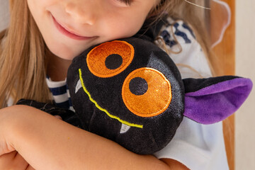 Little girl hugging soft monster toy, happy sweet Child finds comfort in toy, early years, stuffed...