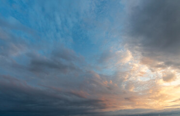 Evening sunset sky background with bright dramatic clouds.