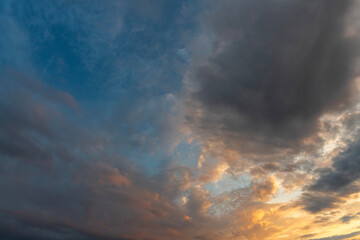 Evening sunset sky background with bright dramatic clouds.