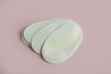 Reusable oval loofah face scrubbies promoting sustainable beauty routine