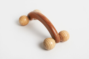 Wooden massage roller relaxing muscles on white background