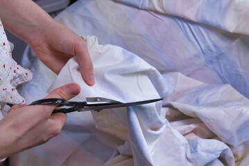 Woman cutting fabric ( side point of view close up)