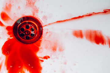 Blood Flowing Down the Drain in Sink.Blood in Sink Near Drain.Blood washing process. Blood dripping down sink drain close up. Crime Scene. © Yuliya