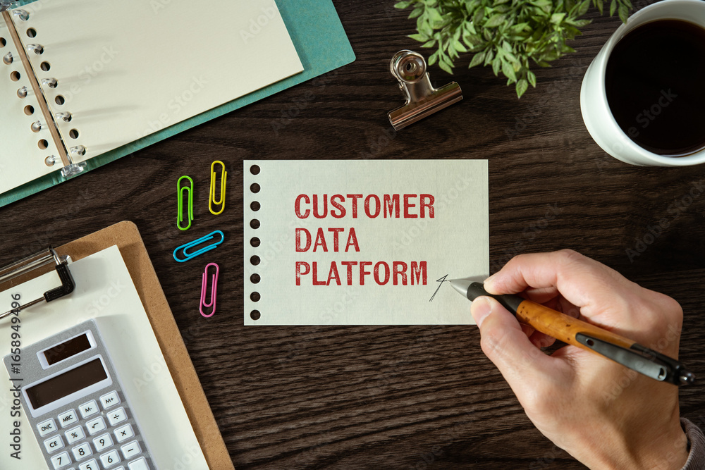 Poster there is notebook with the word customer data platform. it is as an eye-catching image.