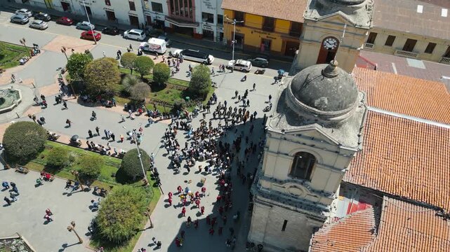 Aerial drone video of crowd outside the church at Plaza de la Constituci&oacute;n, Huancayo