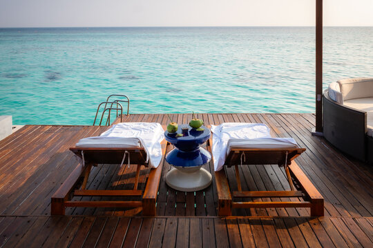 table and chairs on the terrace at a resort in the Maldives