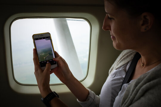 Taking photos with a phone  from a sea plane in Ha Long Bay, Vietnam