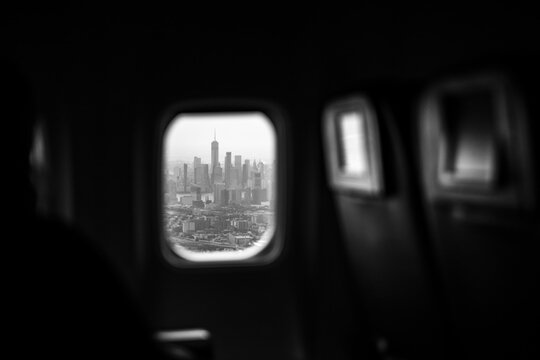 View of the New York City skyline through an airplane window.