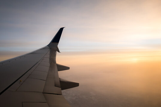 airplane in the sky at sunset