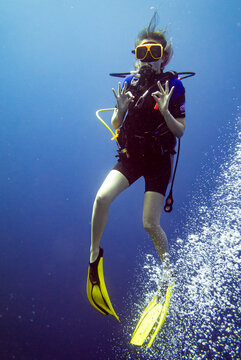 scuba diver giving the ok sign underwater while scuba diving Cura&ccedil;ao
