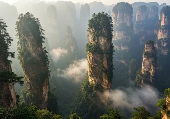 Zhangjiajie Stone Pillars in China with Mist Weaving Through Peaks Wide Cinematic Shot