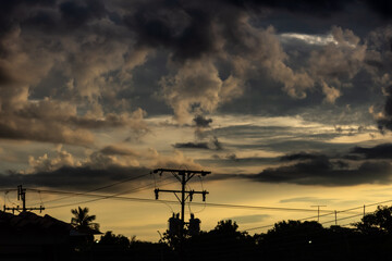 Beautiful sky with cloud and electricity post in the evening at sunset.
