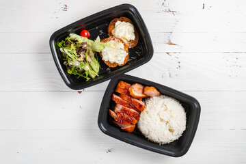top view takeout food of smoked duck breast rice served with salad and bread at horizontal composition