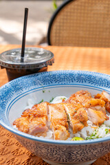 angle view Thai-style chicken with stir-fried Ho Fun or rice noodles and cup of coffee at vertical composition