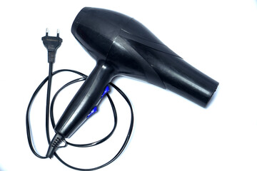 Black electric hair dryer with ergonomic handle, blue control buttons, and power cord isolated on...