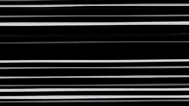 Parallel stripes against dark backdrop