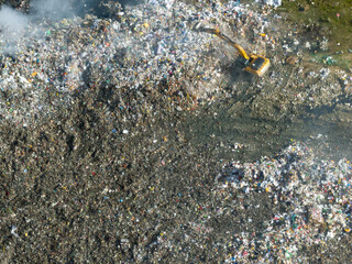 Backhoe working at the garbage dump