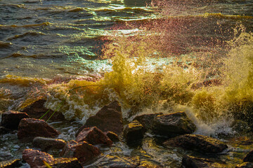 Waves Crashing on Rocky Shore at Sunset