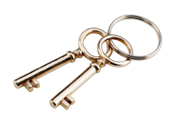 Two antique gold-toned keys linked by a metal ring,  isolated on a black background.  Close-up, showing detail of key heads and ring